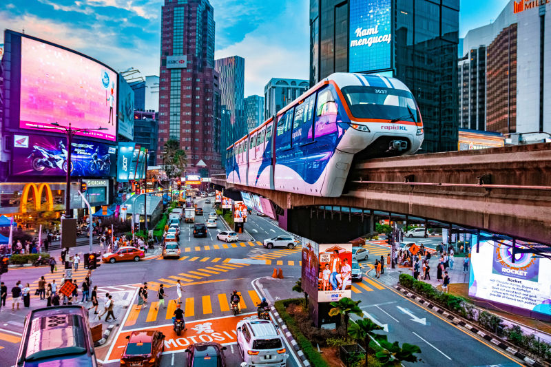 a city street filled with traffic and tall buildings Malaysia